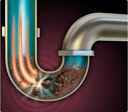 Illustration of a metal sink drainpipe with a U-bend, showing water and debris buildup inside. Orange streaks from an Auckland plumber’s cleaning agent dissolve the clog and clear the blockage.