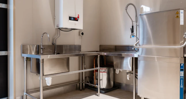 Industrial kitchen sinks and dishwasher.