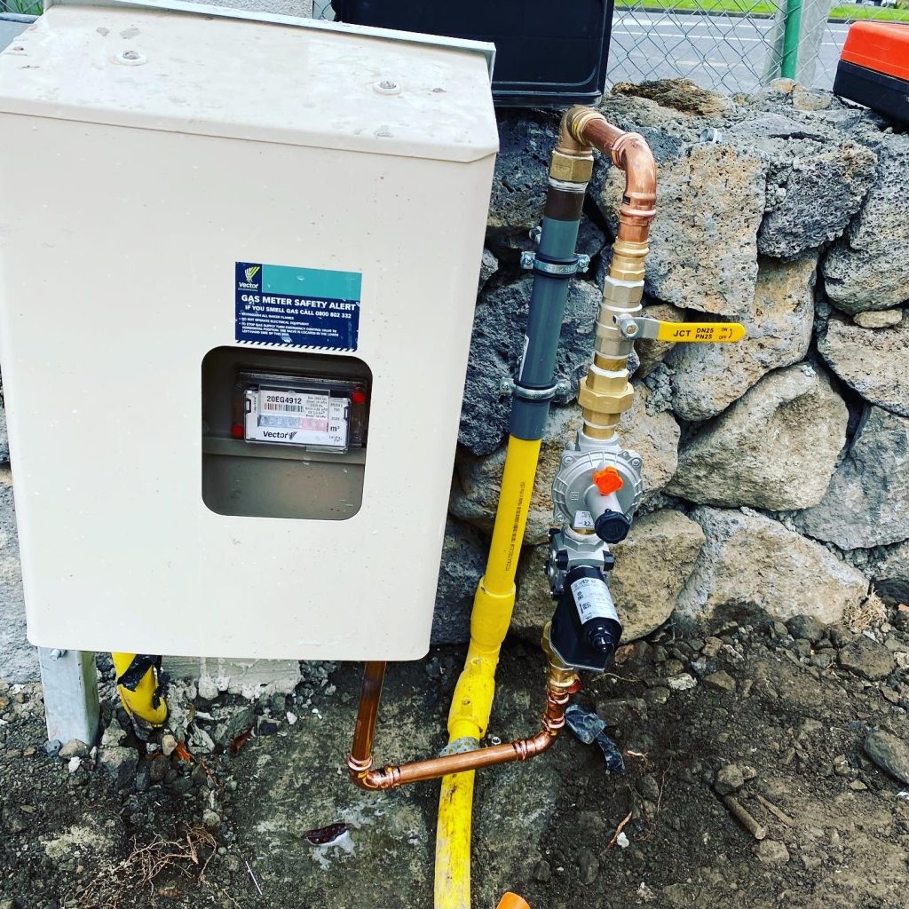 Gas meter setup by rock wall.
