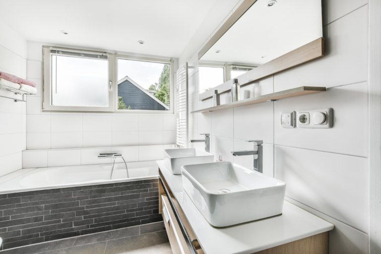 Modern bathroom with tub, double sinks.