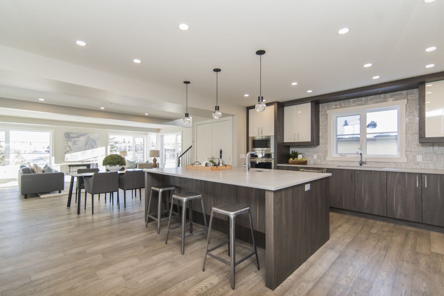 Sleek kitchen, island, dark cabinets.